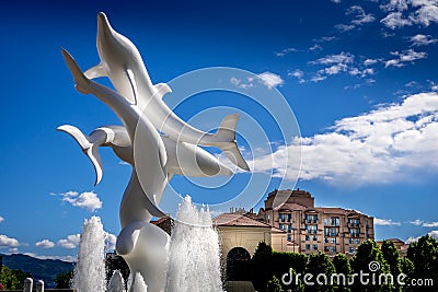 Rhapsody, a group of Fiberglass Dolphins, in a Fountain at Rhapsody Plaza in the city of Kelowna Editorial Stock Photo