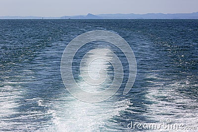 Kelvin wake pattern , kilwater behind the sailing ship, Lake Garda, Italy Stock Photo