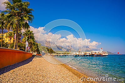 KEMER, TURKEY: Beautiful scenery on the pier on the beach and mountains on a sunny day. Editorial Stock Photo