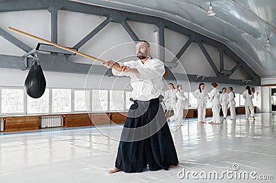 Kendo master practicing with wooden sword during break time on training Stock Photo