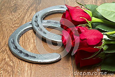 Kentucky Derby Red Roses with Horseshoes on Wood Stock Photo