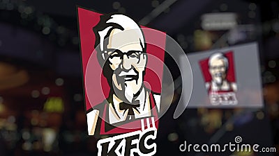 Kentucky Fried Chicken KFC logo on the glass against blurred business center. Editorial 3D rendering Editorial Stock Photo
