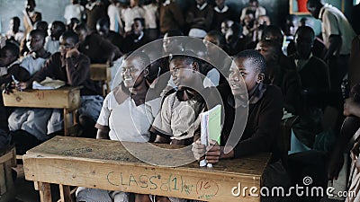 KENYA, KISUMU - MAY 20, 2017: Group of happy African children sitting in classroom and smiling, laughing together. Editorial Stock Photo