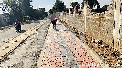 Kenyan roads, bodaboda on local road construction with tile pavements Ziwani in Starehe Constituency in Nairobi Kenya Editorial Stock Photo