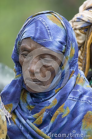 A Kenyan woman with a blue scarf stands in line at the Pepo La Tumaini Jangwani, HIV/AIDS Community Rehabilitation Program, Orphan Editorial Stock Photo