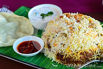 Kerala biryani thali served with curd and papad Stock Photo