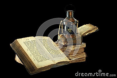 Kerosene lamp and old books. Stock Photo