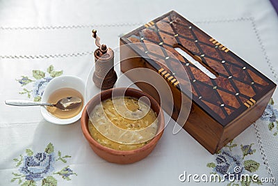 Erishde dish purple backgrounds . Erishde brown bowl . Vinegar on a small white bowl . Wooden napkin box . Kesme, egg noodle , Stock Photo