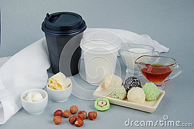 Keto peanut butter, matcha balls and coconut bulletproof, black and white paper cup for coffee, tea break with a lid Stock Photo