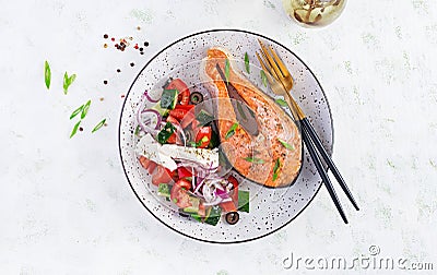 Ketogenic lunch. Baked salmon garnished with greek salad. Healthy dinner. Keto/paleo diet. Stock Photo