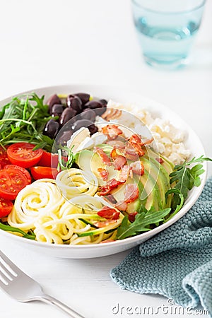 Ketogenic lunch bowl: spiralized courgette with avocado, tomato, feta cheese, olives, bacon Stock Photo