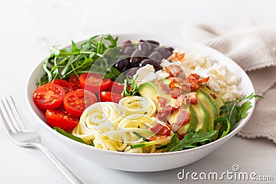 Ketogenic lunch bowl: spiralized courgette with avocado, tomato, feta cheese, olives, bacon Stock Photo