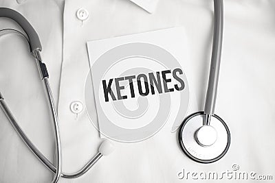 ketones text on white paper on the white background. stethoscope ,glasses and keyboard Stock Photo