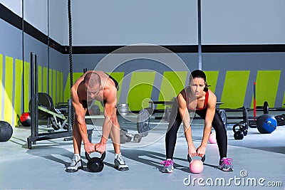 Kettlebells swing crossfit exercise man and woman Stock Photo