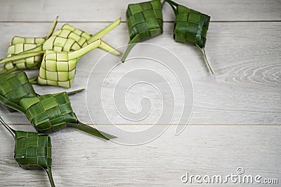 Ketupat background on white wooden board. Ketupat frame with copy paste for your text or design. Idul Fitri traditional Stock Photo