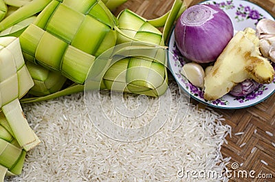 Ketupat casing and rice in bamboo container. Stock Photo