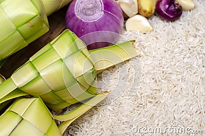 Ketupat casing and rice in bamboo container. Stock Photo