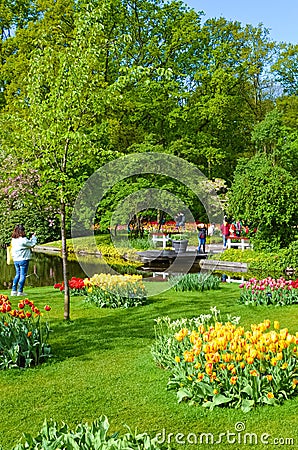 Keukenhof, Lisse, Netherlands - Apr 28th 2019: Visitors taking pictures of marvelous Keukenhof gardens in spring. Famous Dutch Editorial Stock Photo