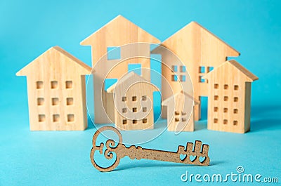 Key on the background of miniature wooden houses. Real estate buying and selling concept. Affordable housing. Mortgages and loans Stock Photo