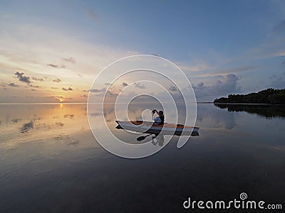 Woman kayaking at sunrise in Bear Cut, Florida. Editorial Stock Photo