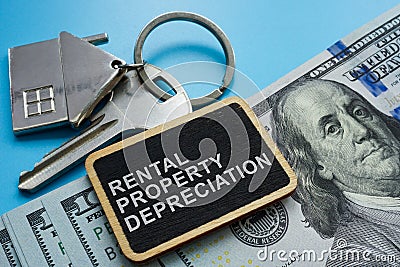 Key, cash and plate with sign Rental property depreciation. Stock Photo