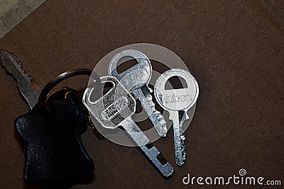 Key with keyholder in brown background Stock Photo
