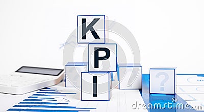 Key performance indicators. Cubes with KPI text, calculator and graphs. Business targets setting, measurement and Stock Photo