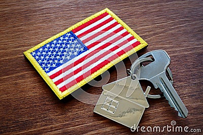 Key from property and USA flag. VA loan mortgage. Stock Photo