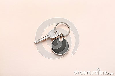 Key with stylish keychain on light background Stock Photo