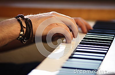 On the keyboard instrument men`s hands press the keys Stock Photo