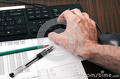 Keyboard with man`s hand, mouse, papers, pen and pencil Stock Photo