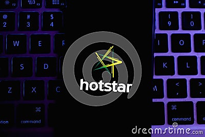 Keyboard and smart phone with the Hotstar logo Editorial Stock Photo