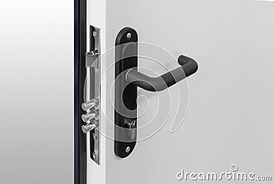 Keyhole and bolts at black white door with black handle Stock Photo