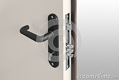 Keyhole and bolts at brown white door with black handle Stock Photo