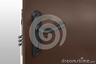 Keyhole and bolts at brown white door with black handle Stock Photo