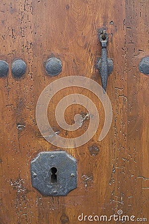 Keyhole in a rustic door. Stock Photo