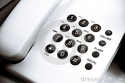 Keypad for telephonic communication or low angle view of a white office dial up landline Stock Photo