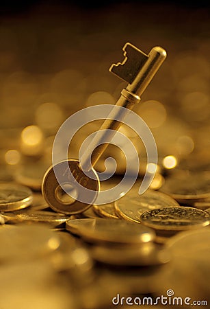 Keys on a heaped of gold coins Stock Photo