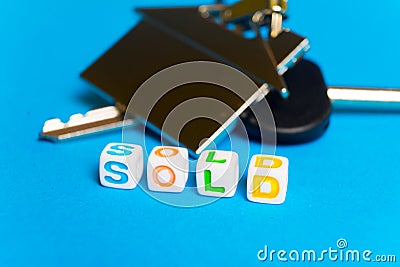 Keys with a keychain form the house and the inscription on the sale Stock Photo
