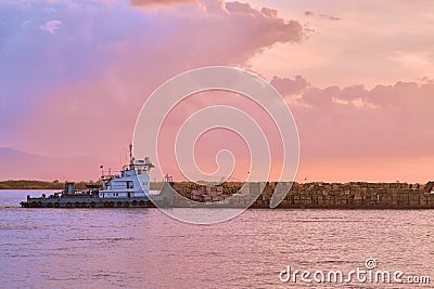 Khabarovsk, Russia - Sep 29, 2021: Sunset on the embankment of the Amur river in Khabarovsk. A barge with timber floats Editorial Stock Photo