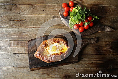 Khachapuri Adjara traditional Georgian dishes. Baked bread stuffed with cheese and eggs. Stock Photo