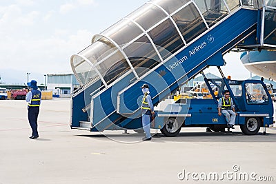 Khanh Hoa, Vietnam - July 30, 2016: Vietnam Airlines stairs ready for passenger to step down, with aviation service staffs in Cam Editorial Stock Photo