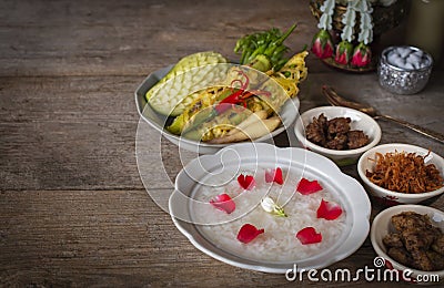 Khao-Chae, Cooked Rice Soaked in Iced Water in the white bowl and Eaten with the Usual Complementary Food and to decorate by Stock Photo