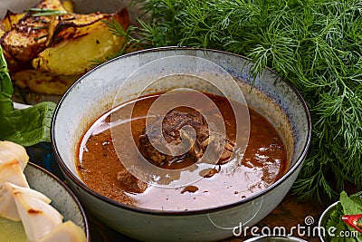 Kharcho delicious soup in a bowl. Harcho soup with beef, rice, cherry plum puree and chopped walnuts Stock Photo