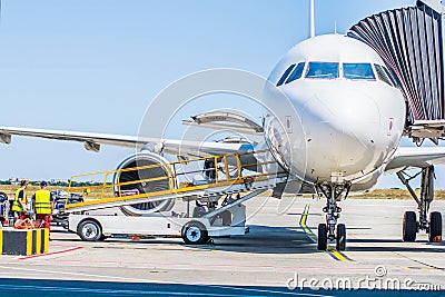 Kharkiv, Ukraine - August 19, 2018: Loading baggage on a plane. Ground staff handling an aircraft before departure Editorial Stock Photo