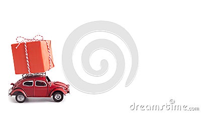 Red small car Volkswagen Beetle with Christmas or New Year gift on white Editorial Stock Photo
