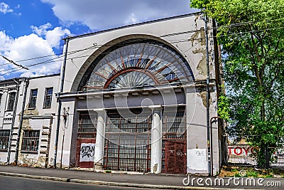 Old industrial building with large arched windows on Chervoni Ryady Street in Kharkov. Cityscape Editorial Stock Photo