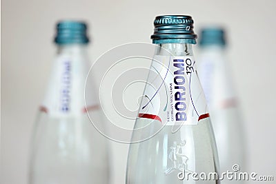 KHARKOV, UKRAINE - JULY 2, 2021: Glass of Borjomi brand of naturally carbonated mineral water from springs in Borjomi Gorge of Editorial Stock Photo