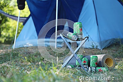 KHARKOV, UKRAINE - JULY 31, 2021: Green tin cans of Heineken lager beer produced by the Dutch brewing company Heineken N.V Editorial Stock Photo