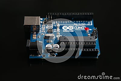 Arduino UNO board on black background Editorial Stock Photo